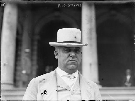 Senator A. O. Stanley in a white suit standing on the steps of the Capitol