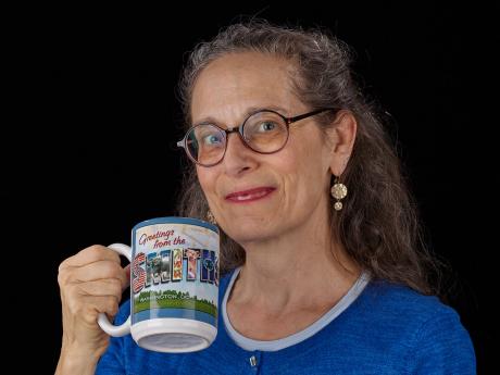 Jessica Warner holds a Smithsonian mug and smiles